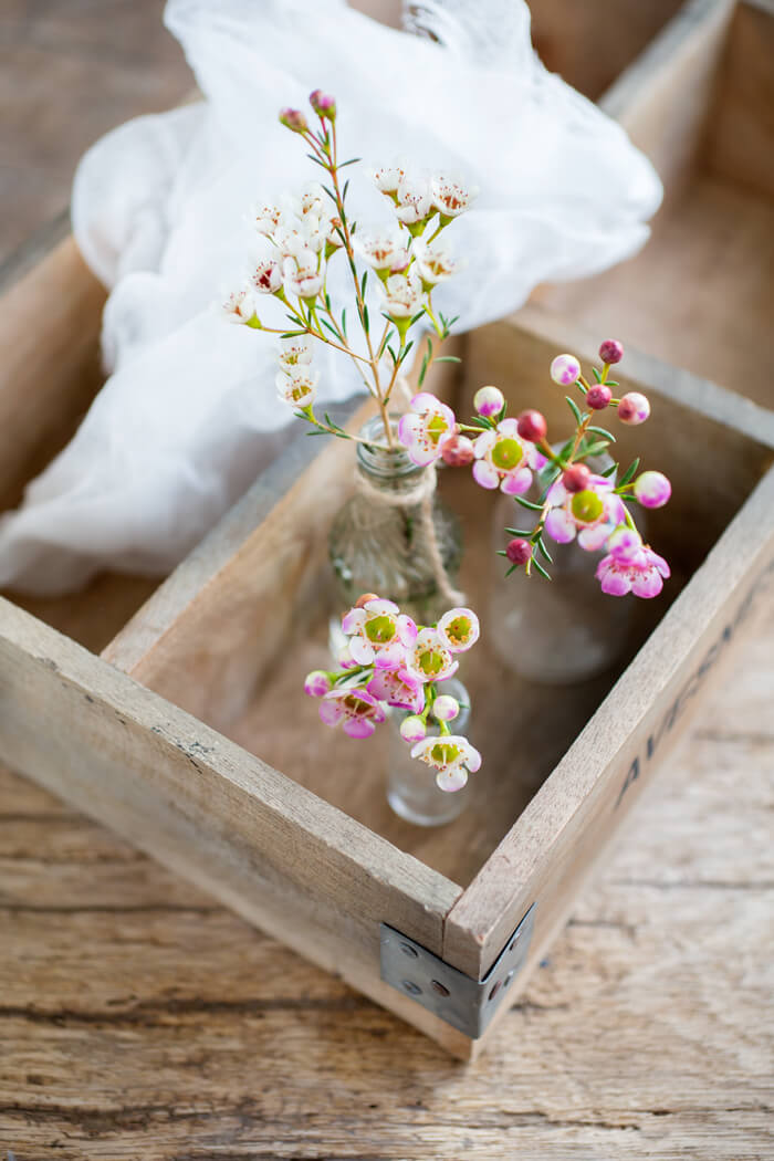 wax flowers in little vases