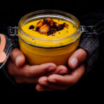 Roasted carrot soup hold in a glas